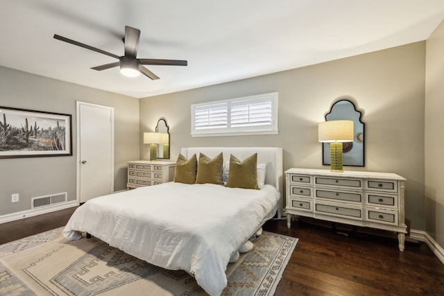 bedroom with baseboards, visible vents, ceiling fan, and dark wood-type flooring