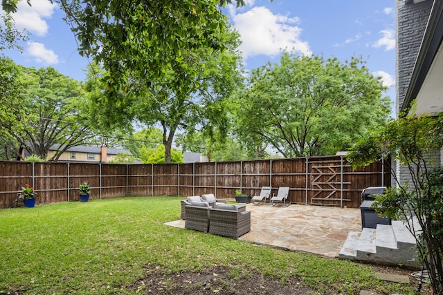 view of yard with a fenced backyard, a patio, and outdoor lounge area