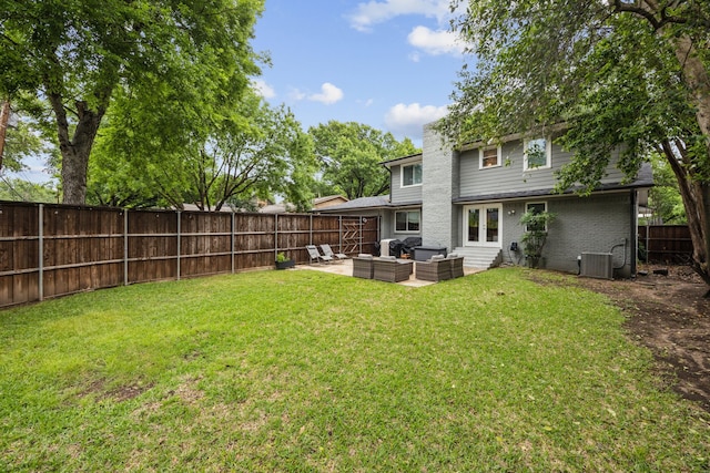 back of property with a lawn, brick siding, an outdoor living space, and a fenced backyard
