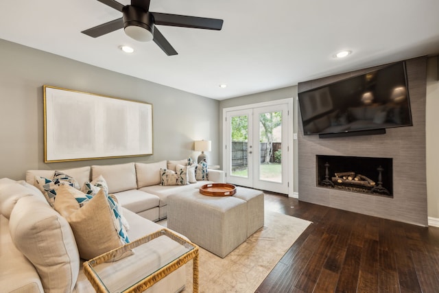 living room with recessed lighting, ceiling fan, dark wood finished floors, and a large fireplace