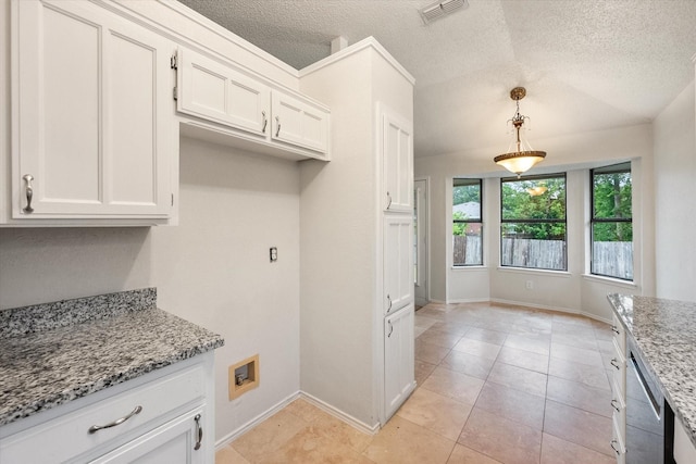 kitchen with light stone counters, white cabinets, dishwasher, and visible vents