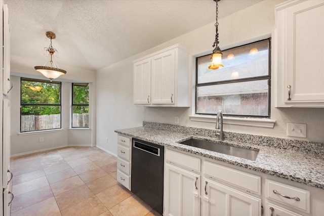kitchen with a textured ceiling, decorative light fixtures, a sink, and dishwasher