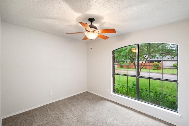 unfurnished room with baseboards, a ceiling fan, carpet, and a healthy amount of sunlight