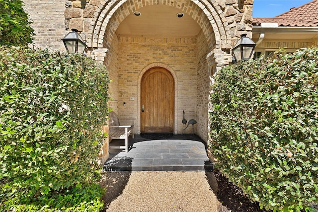 property entrance featuring brick siding