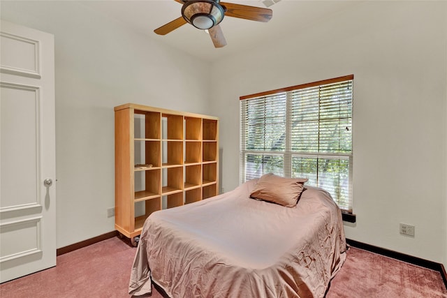carpeted bedroom featuring baseboards and a ceiling fan