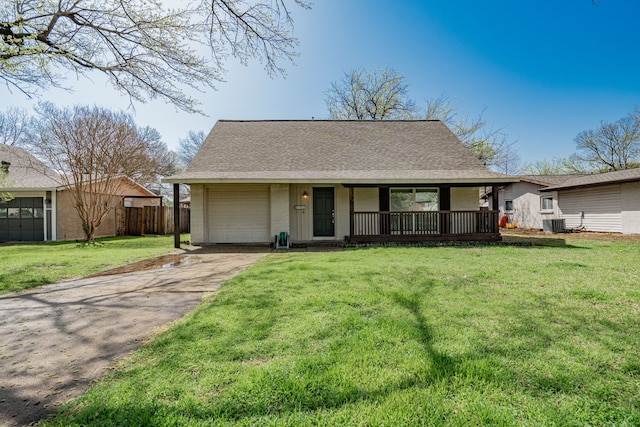 view of front of home with fence, a front yard, roof with shingles, an attached garage, and driveway