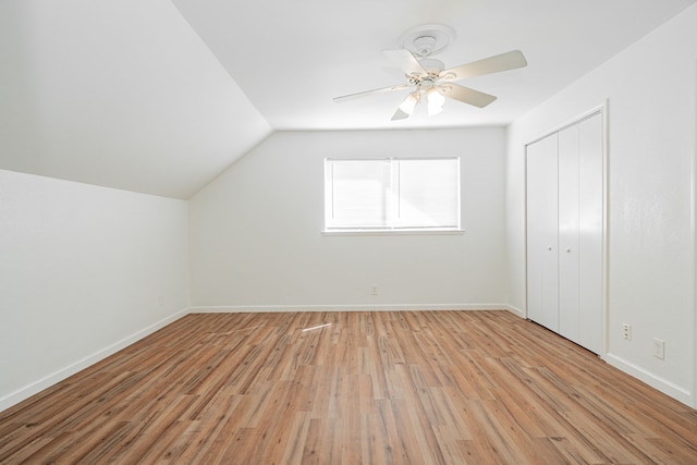 additional living space featuring ceiling fan, lofted ceiling, baseboards, and light wood finished floors
