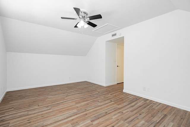 bonus room with visible vents, wood finished floors, baseboards, a ceiling fan, and vaulted ceiling