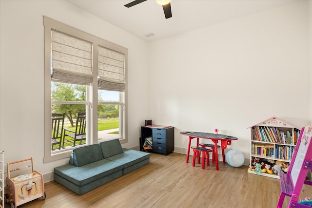 playroom featuring a ceiling fan, wood finished floors, and visible vents