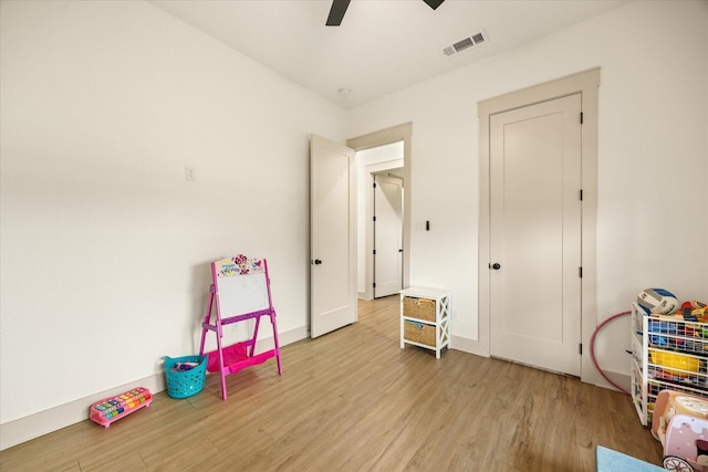 game room featuring ceiling fan, light wood finished floors, and visible vents
