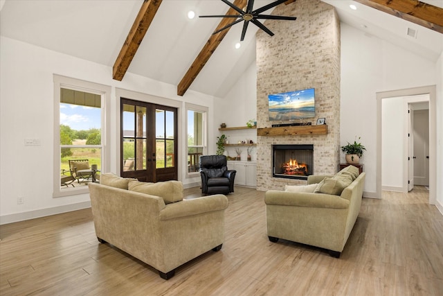 living room featuring baseboards, ceiling fan, high vaulted ceiling, and beam ceiling