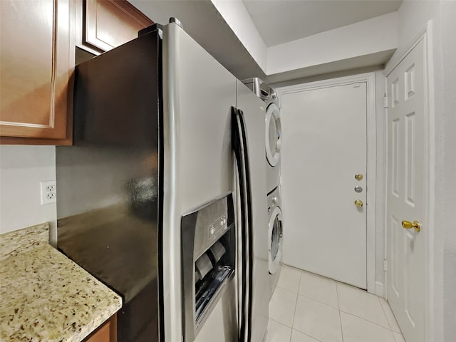 3105 San Jacinto St Unit 108, Dallas, TX 75204 - laundry room with laundry area, stacked washing maching and dryer, and light tile patterned flooring