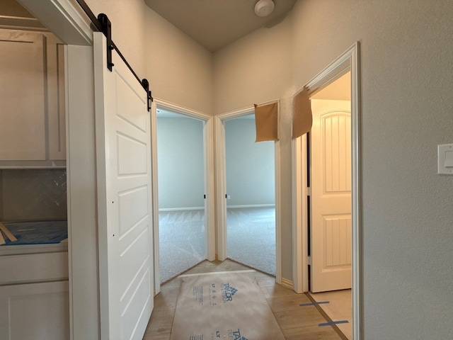 505 Ashlow Ct, Springtown, TX 76082 - hallway with a barn door and a textured wall