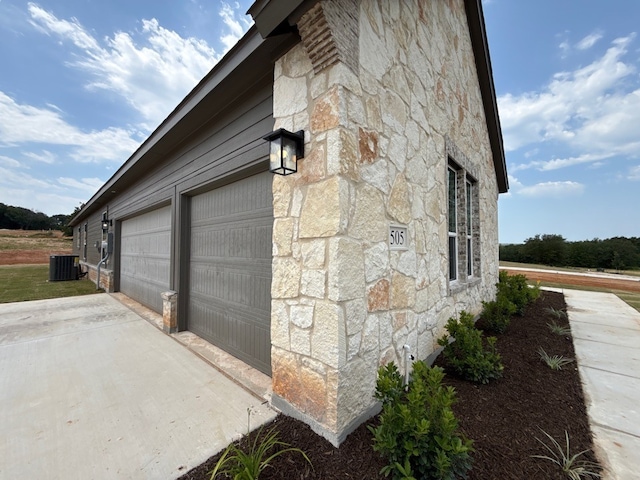 505 Ashlow Ct, Springtown, TX 76082 - view of property exterior featuring stone siding, a garage, and concrete driveway