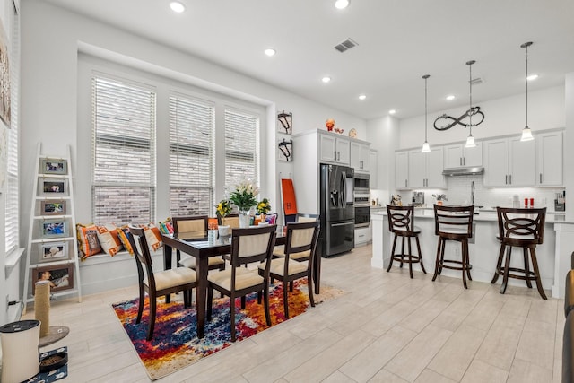 dining area featuring visible vents, recessed lighting, and light wood-style flooring