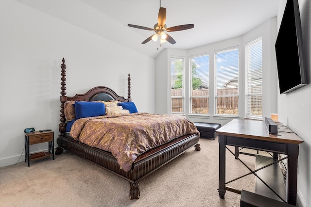 bedroom with a ceiling fan, lofted ceiling, and light colored carpet