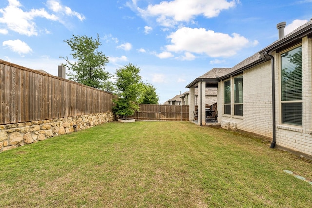 view of yard with a fenced backyard