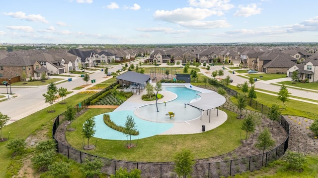 view of pool featuring a residential view and fence