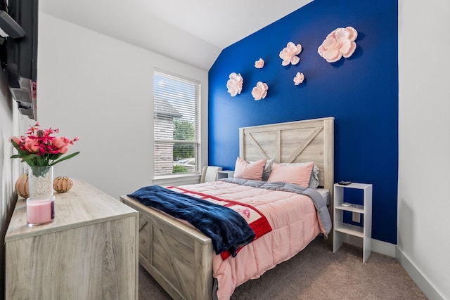 bedroom with baseboards, lofted ceiling, and carpet