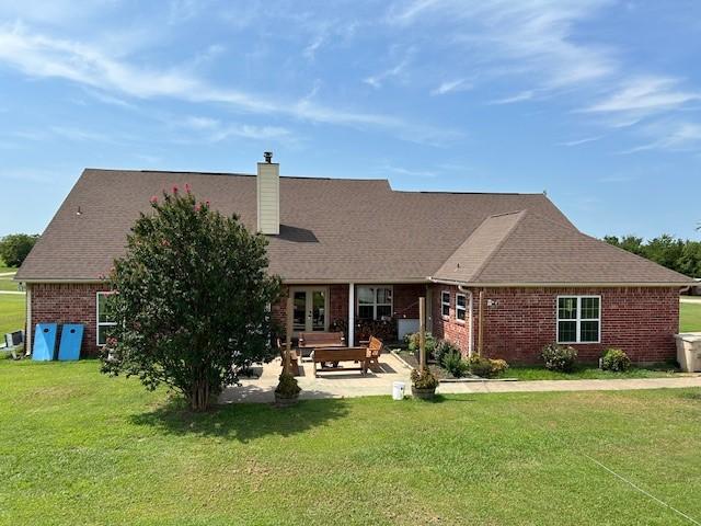 284 County Road 2388, Pickton, TX 75471 - back of property with a patio, french doors, a chimney, brick siding, and a yard