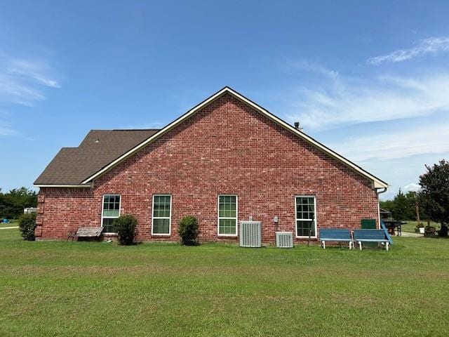 284 County Road 2388, Pickton, TX 75471 - view of side of property featuring a yard, brick siding, and cooling unit