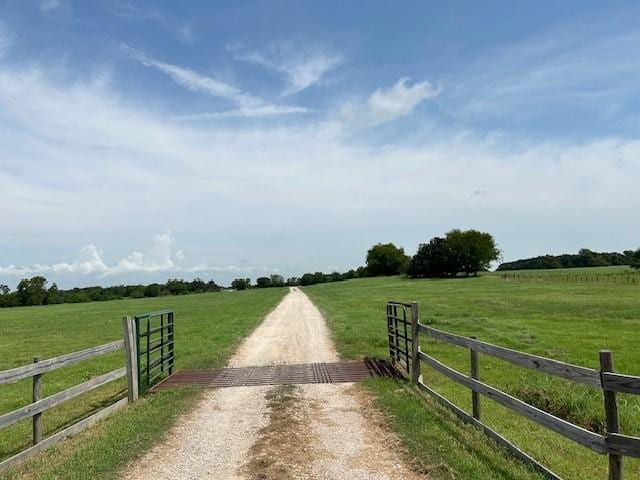 284 County Road 2388, Pickton, TX 75471 - view of road with a rural view, a gated entry, and dirt driveway