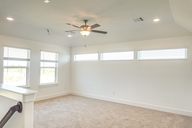 spare room featuring light colored carpet, baseboards, and visible vents