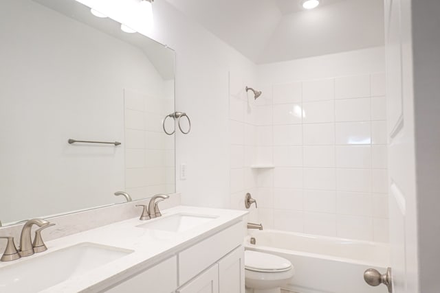 full bath featuring shower / bath combination, a sink, double vanity, and toilet