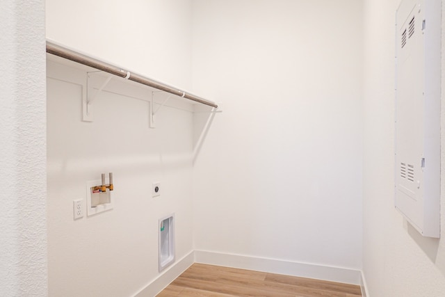 washroom with laundry area, washer hookup, light wood finished floors, baseboards, and hookup for an electric dryer