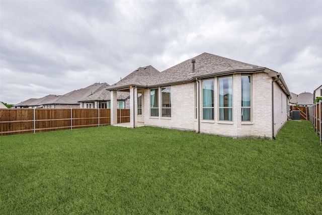 4012 Prickly Pear Ave, Aubrey, TX 76227 - rear view of house with a fenced backyard, a lawn, roof with shingles, and brick siding