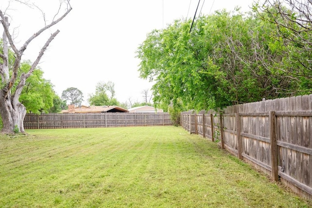 view of yard with a fenced backyard