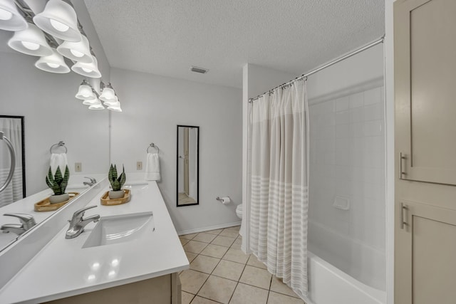 bathroom with visible vents, a sink, a textured ceiling, and tile patterned flooring