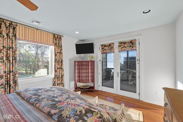 bedroom featuring visible vents, wood finished floors, access to exterior, baseboards, and recessed lighting