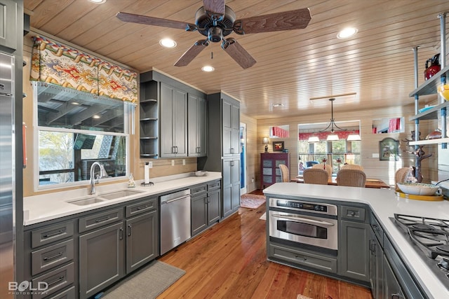 kitchen featuring a sink, open shelves, wooden ceiling, and stainless steel appliances