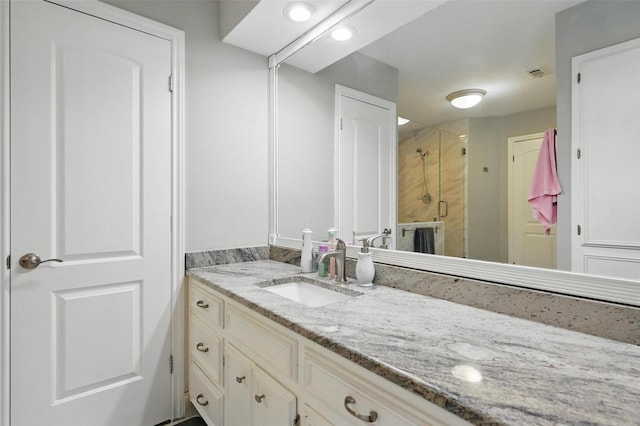 full bathroom featuring visible vents, a shower stall, and vanity