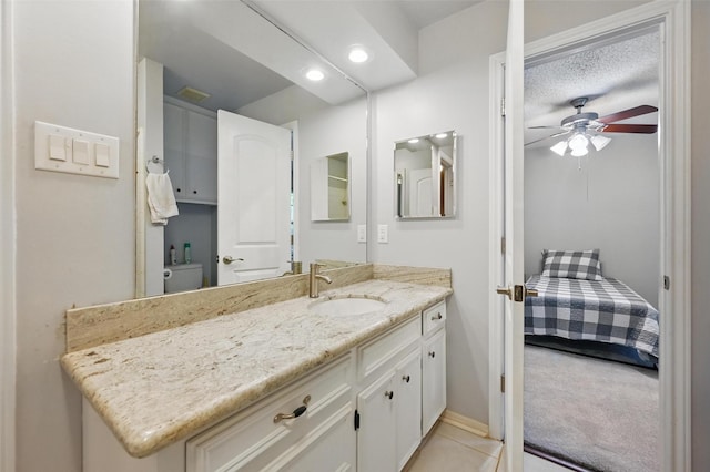 bathroom featuring vanity, tile patterned flooring, baseboards, recessed lighting, and a ceiling fan