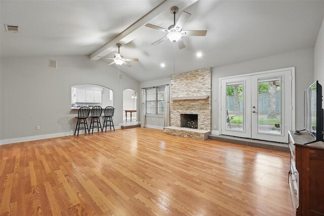 5608 Trail Lake Dr, Arlington, TX 76016 - unfurnished living room featuring light wood-type flooring, arched walkways, a ceiling fan, and baseboards