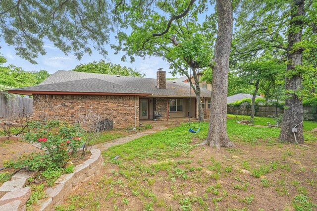 5608 Trail Lake Dr, Arlington, TX 76016 - back of house with a chimney, roof with shingles, and brick siding