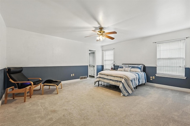 carpeted bedroom featuring visible vents, baseboards, and ceiling fan