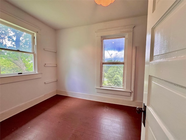 900 Park Dr, Hillsboro, TX 76645 - empty room with dark wood-style flooring and baseboards
