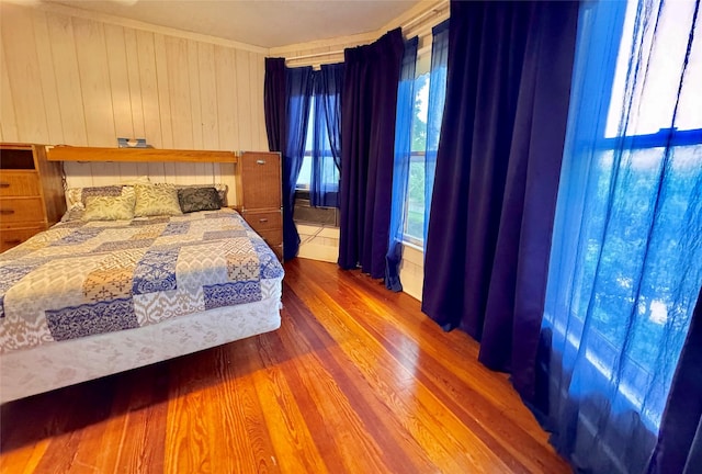 900 Park Dr, Hillsboro, TX 76645 - bedroom with wood finished floors and wooden walls