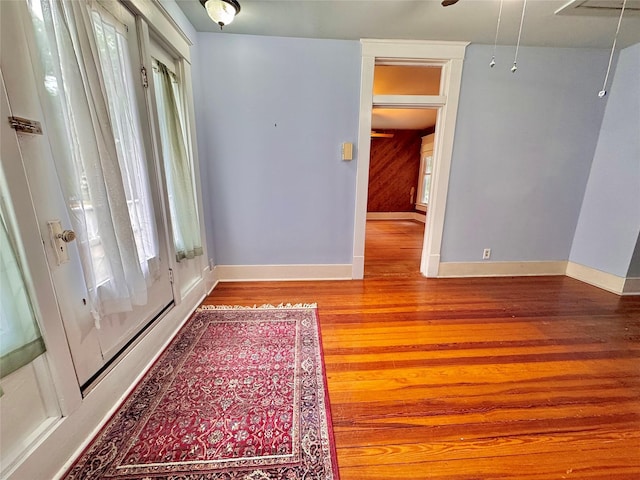 900 Park Dr, Hillsboro, TX 76645 - empty room featuring baseboards, attic access, and wood finished floors