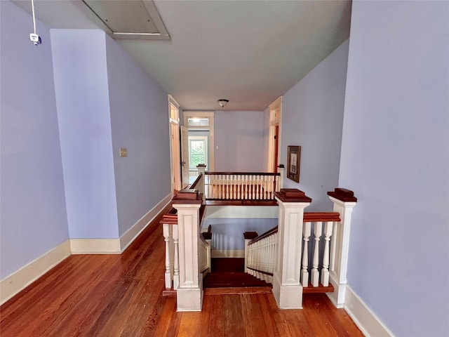 900 Park Dr, Hillsboro, TX 76645 - stairway featuring baseboards, wood finished floors, and attic access