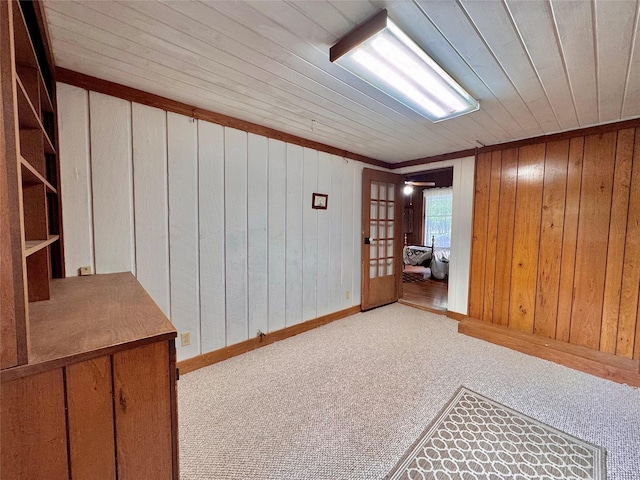 900 Park Dr, Hillsboro, TX 76645 - spare room featuring carpet flooring and wooden walls