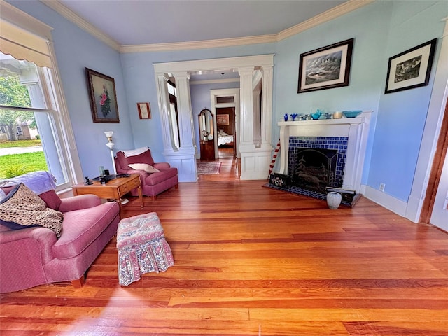 900 Park Dr, Hillsboro, TX 76645 - living area with ornate columns, ornamental molding, light wood-style floors, and a fireplace