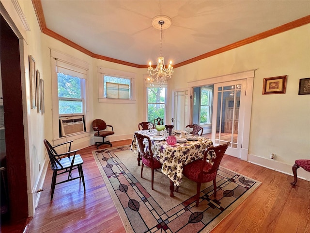 900 Park Dr, Hillsboro, TX 76645 - dining area with baseboards, an inviting chandelier, ornamental molding, and wood finished floors