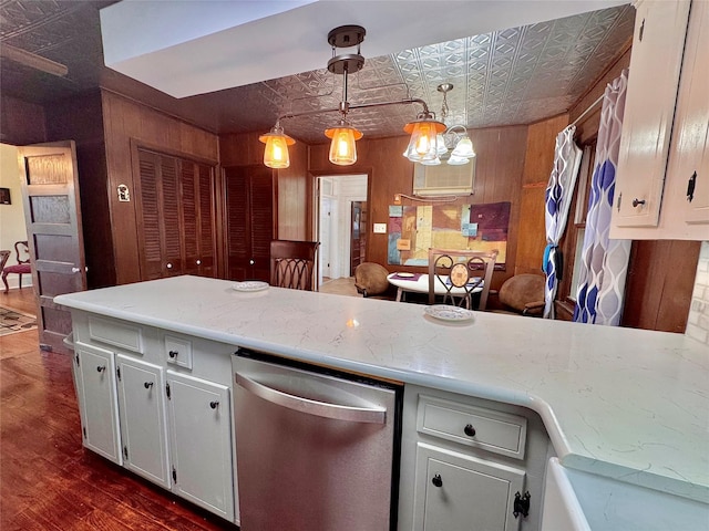 900 Park Dr, Hillsboro, TX 76645 - kitchen featuring decorative light fixtures, stainless steel dishwasher, wood walls, an ornate ceiling, and dark wood-type flooring