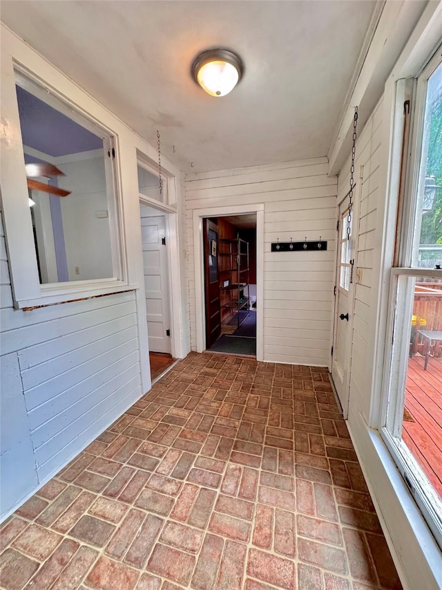 900 Park Dr, Hillsboro, TX 76645 - hall with brick floor and wood walls