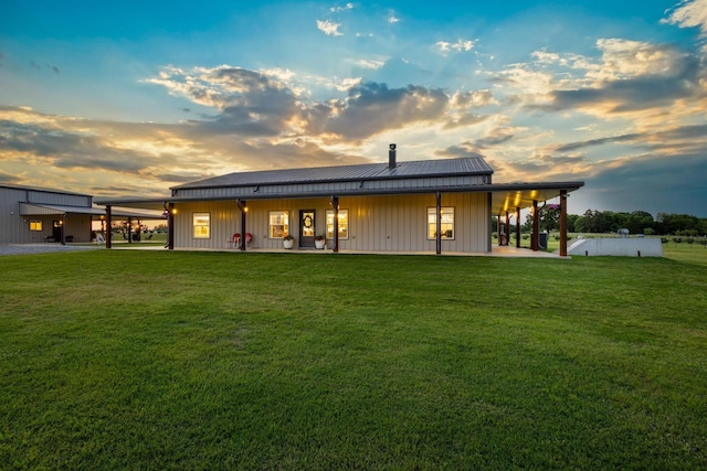 275 Ed Dutton Rd, Pottsboro, TX 75076 - back of property at dusk featuring a lawn, metal roof, a patio area, and a standing seam roof