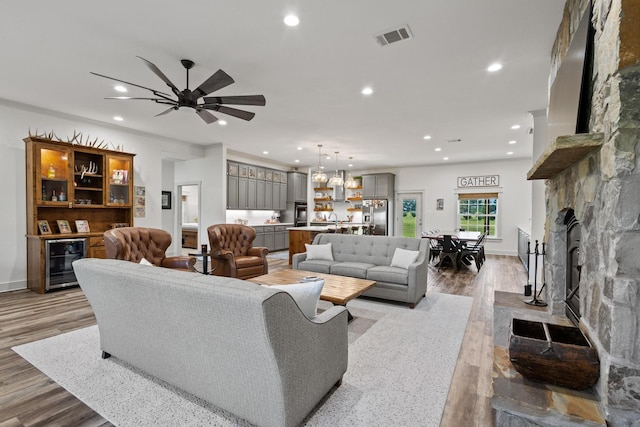275 Ed Dutton Rd, Pottsboro, TX 75076 - living area with recessed lighting, a fireplace, wine cooler, ceiling fan, and wood finished floors